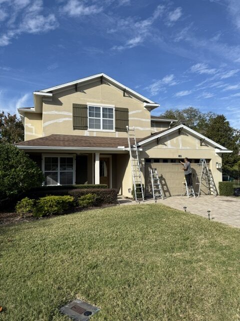 Ladders set along a home exterior for fascia and soffit replacement