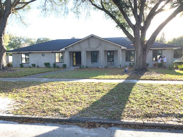 Home with paver banding along a concrete driveway